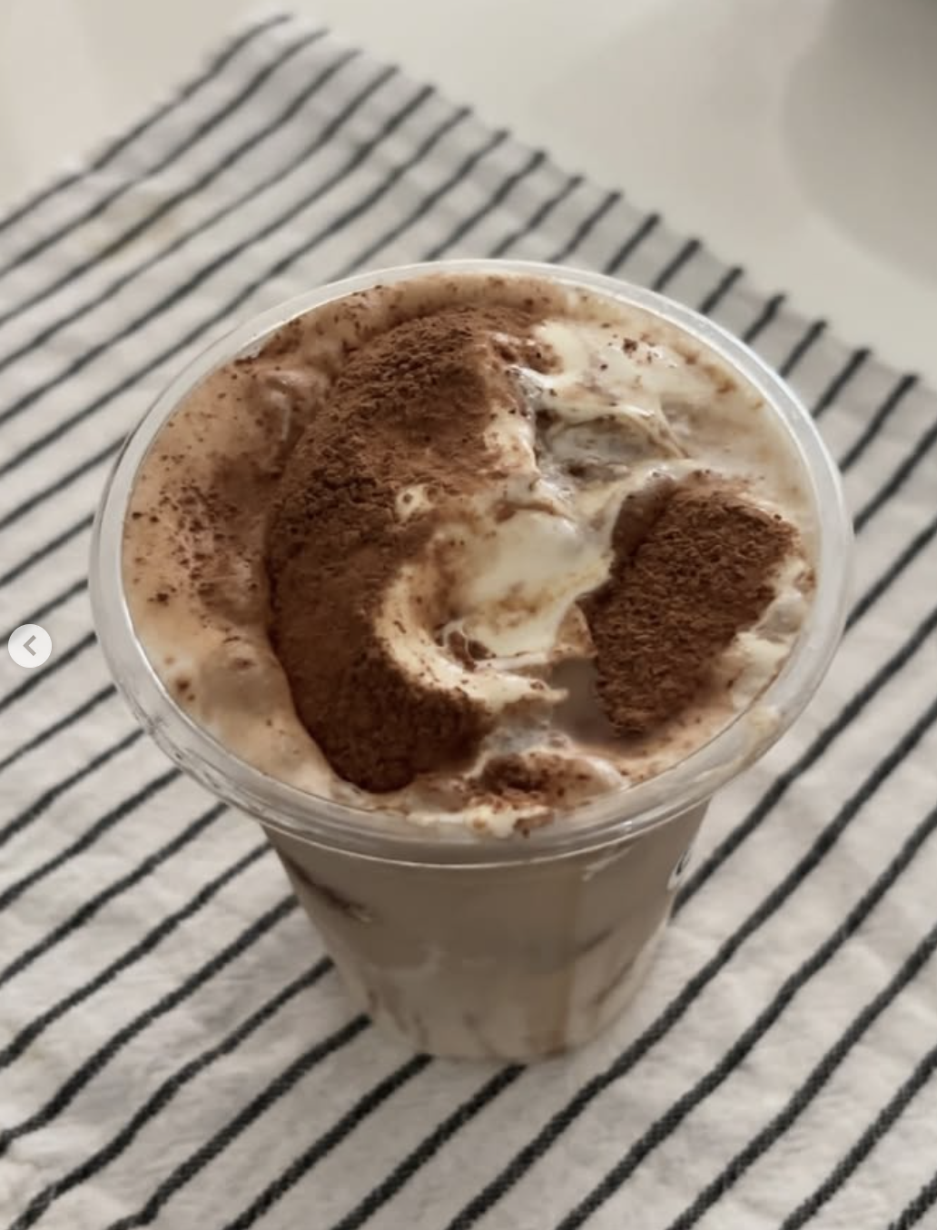 Top-down view of a Bado cloud coffee with cocoa dusted foam