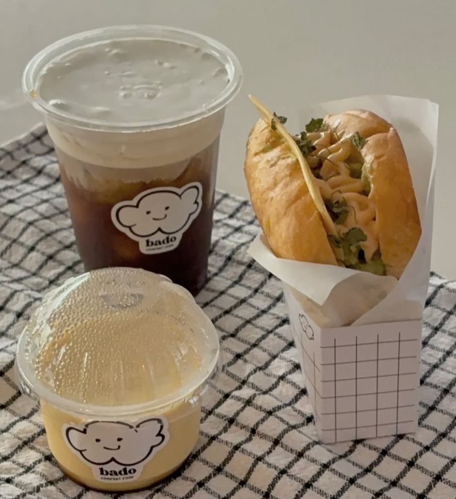 Bado cold foam coffee, custard pudding cup and a sandwich on a checked cloth