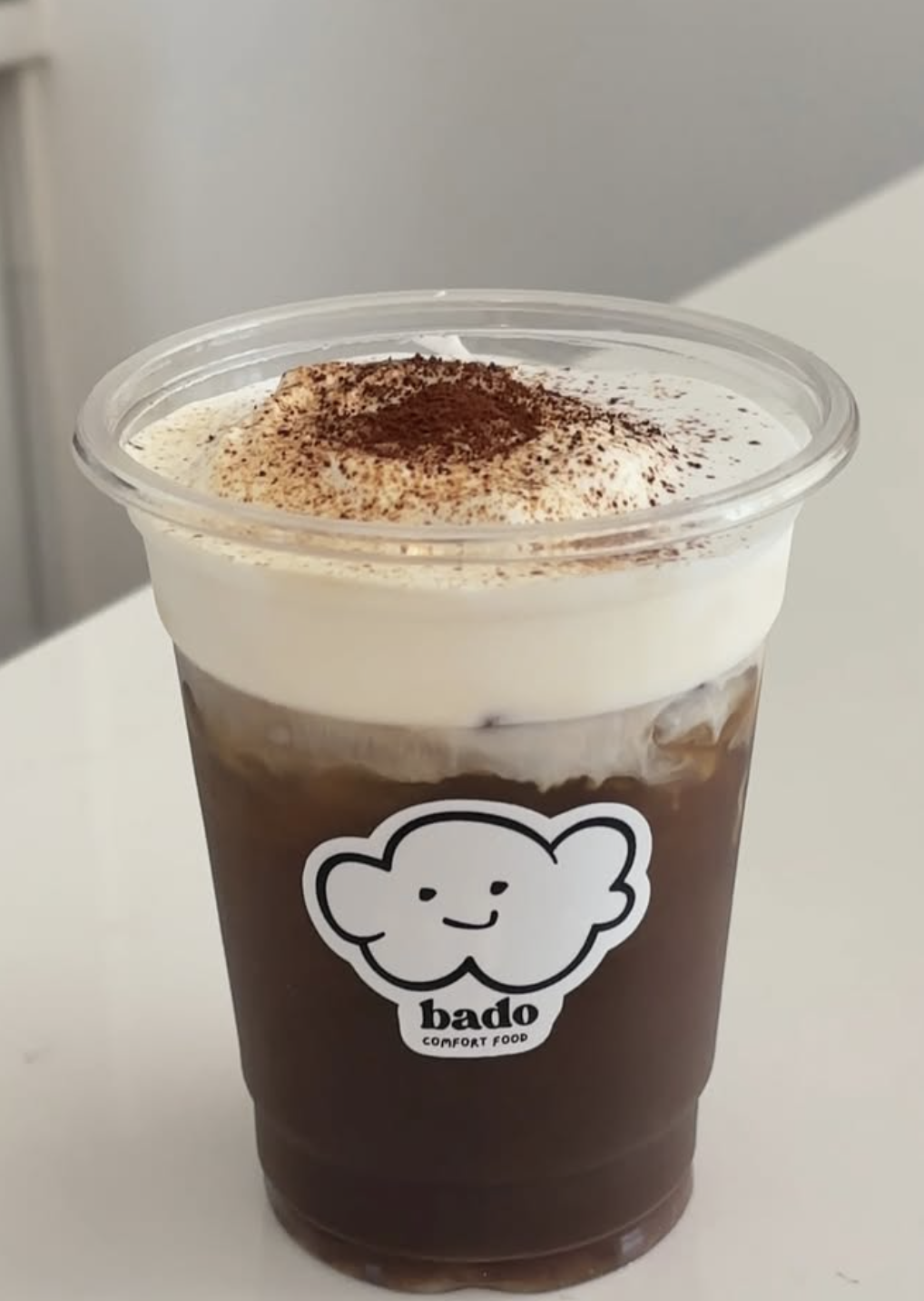 Bado Espresso Cold Foam — dark espresso under a thick cloud of whipped cream with cocoa dust
